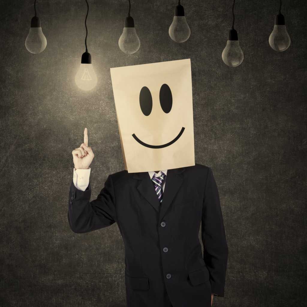 Exec with smiley face bag on head and light bulbs