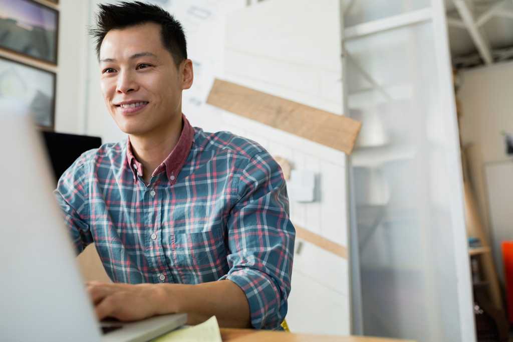 stock photo smiling designer working at laptop 105027643