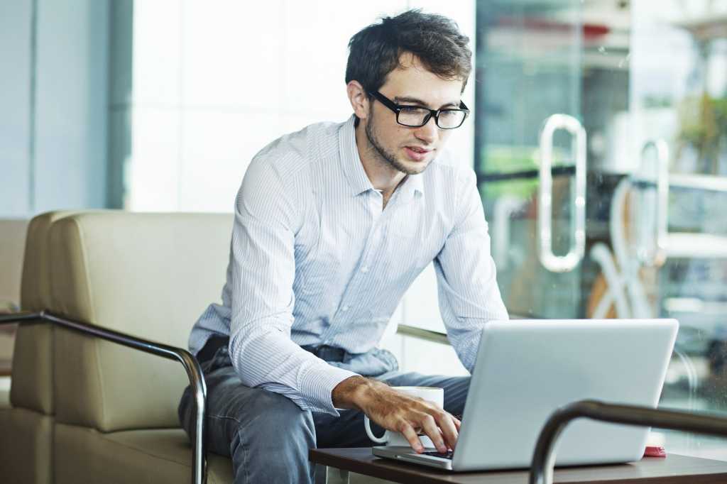 young artsy millennial sitting as laptop