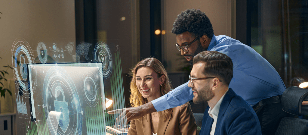 office workers collaborating at desk with screen