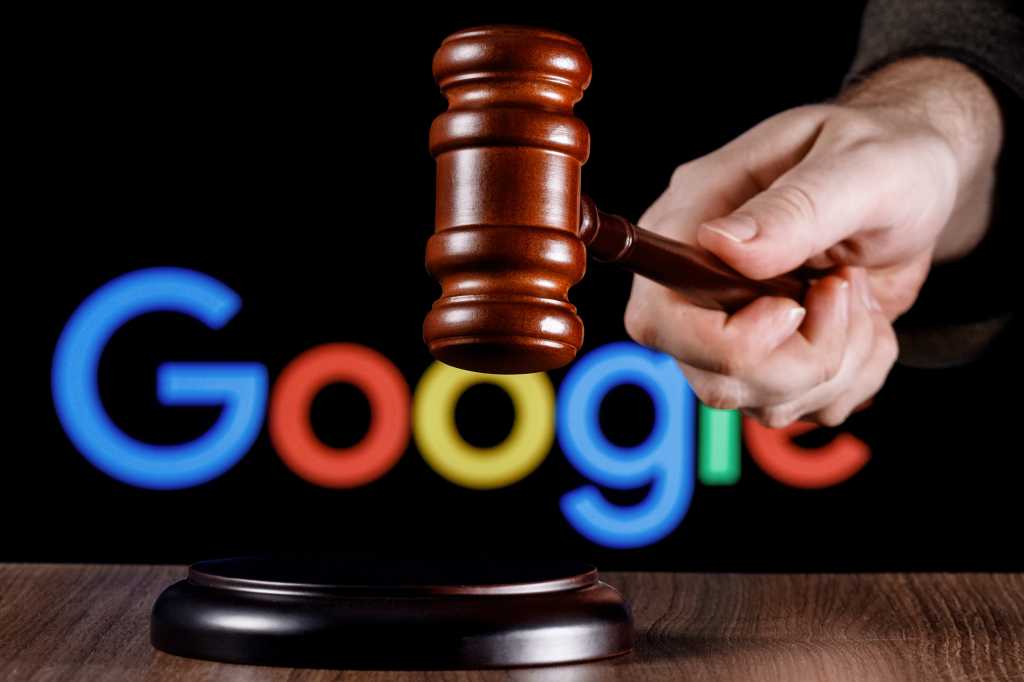 2111602952 Kazan, Russia - Jan 22, 2022: Gavel in hand against the background of Google technology company logo. The concept of the trial.