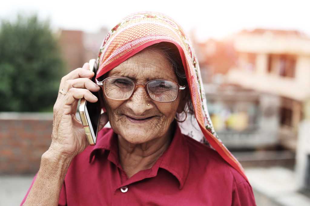 Older woman on cell phone in India